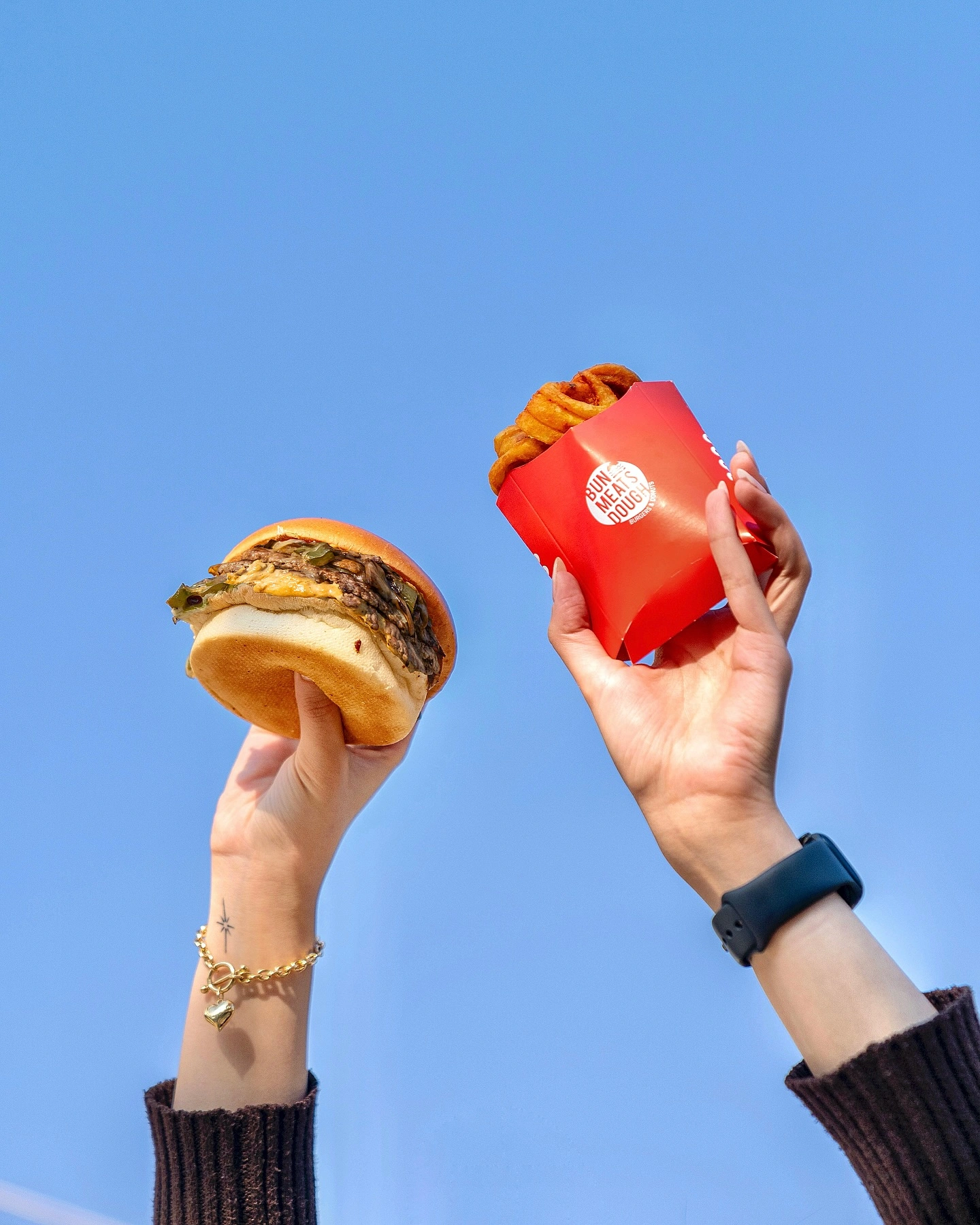 An original Bun Meats Dough photo of a burger and their red fries carton